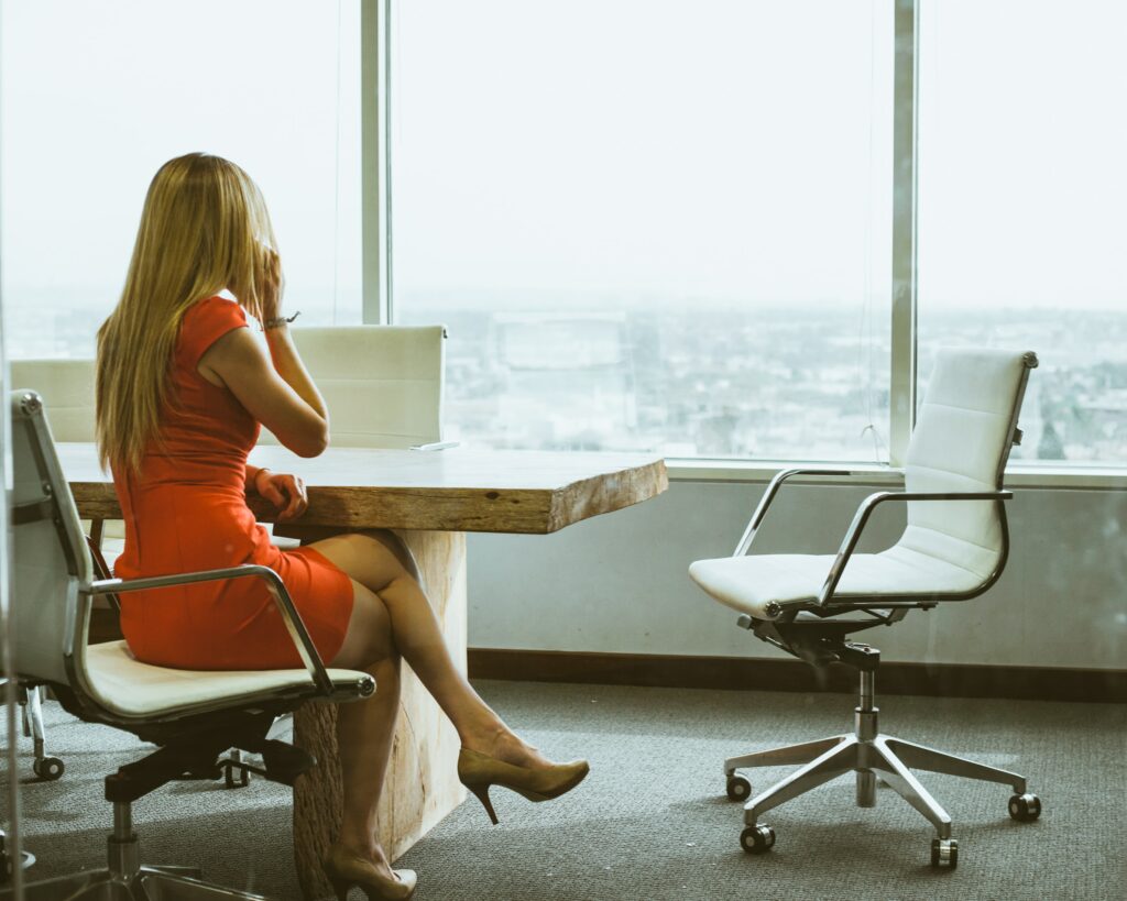 woman talking to local clients on phone in office